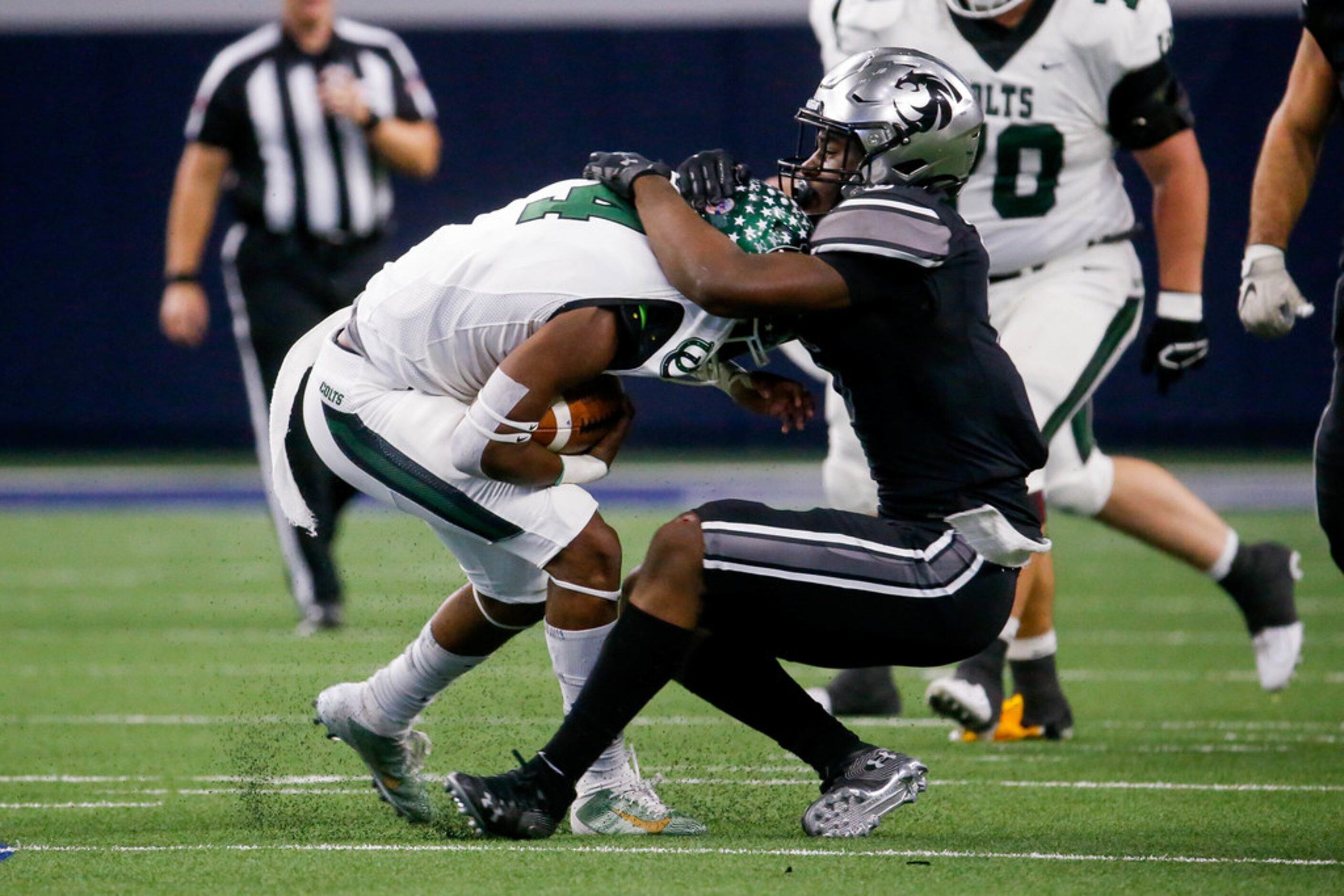 Arlington's quarterback Jahari Rogers (4) is sacked by Guyer's Jordan Eubanks in the second...