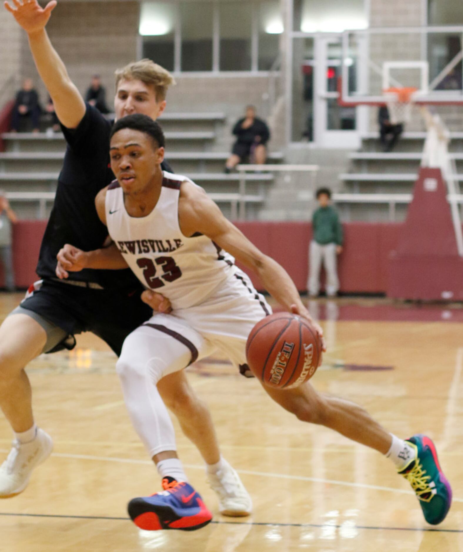 Lewisville's Kylin Green (23) drives hard to the basket as he is guarded by Coppell's Ben...
