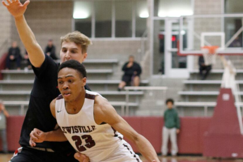 Lewisville's Kylin Green (23) drives hard to the basket as he is guarded by Coppell's Ben...