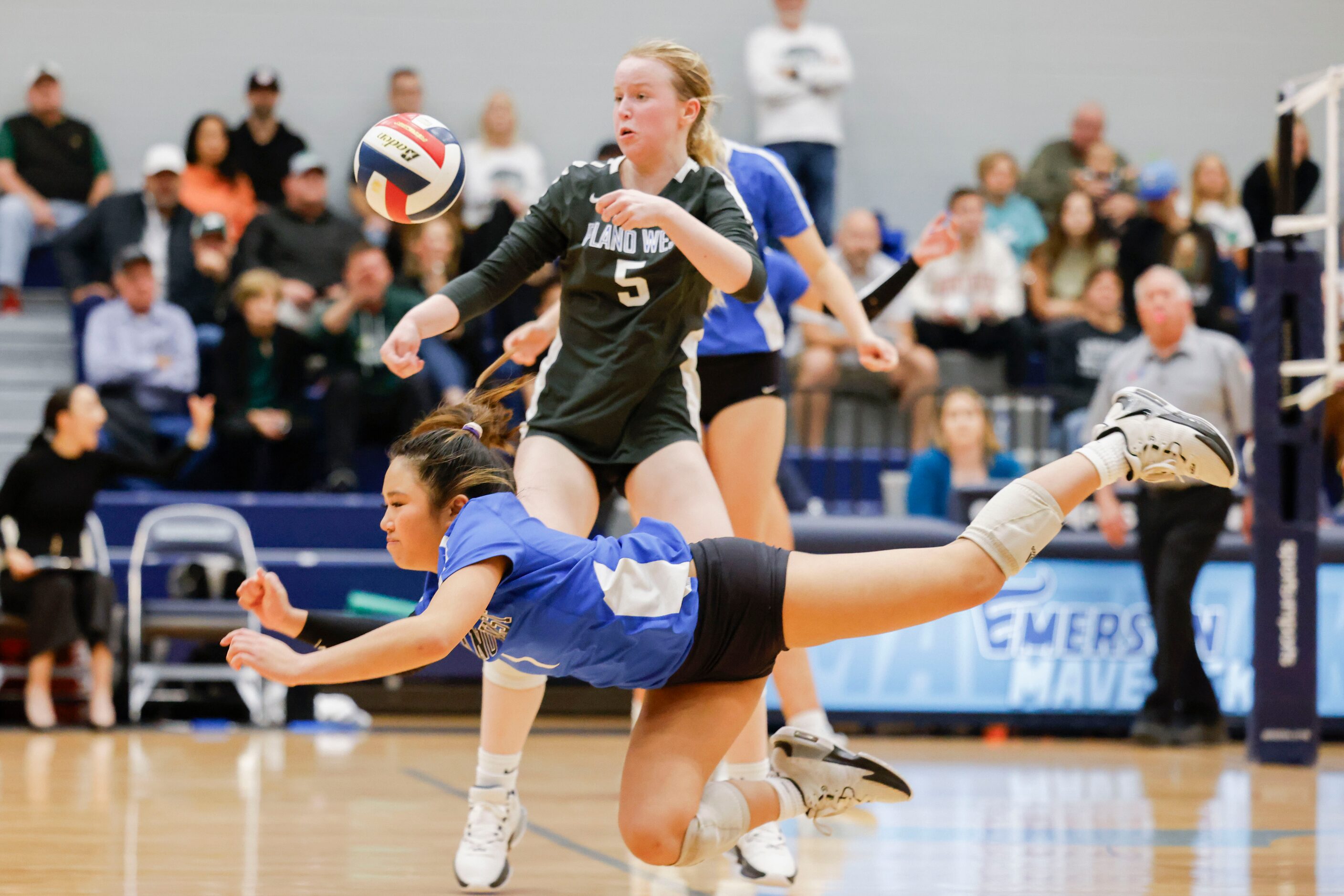 Plano West’s Dakota Huynh (front) attempts to recieve a pass as Ella Willenborg (back)...