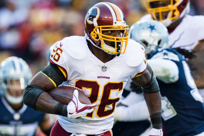 Washington Redskins running back Adrian Peterson (26) runs the ball during the first half of...