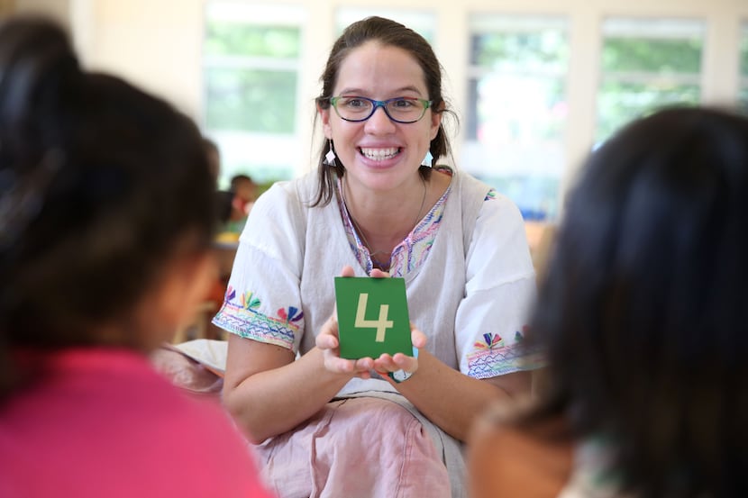 Montessori guide Lucia Martinez teaches students during an early childhood education program...