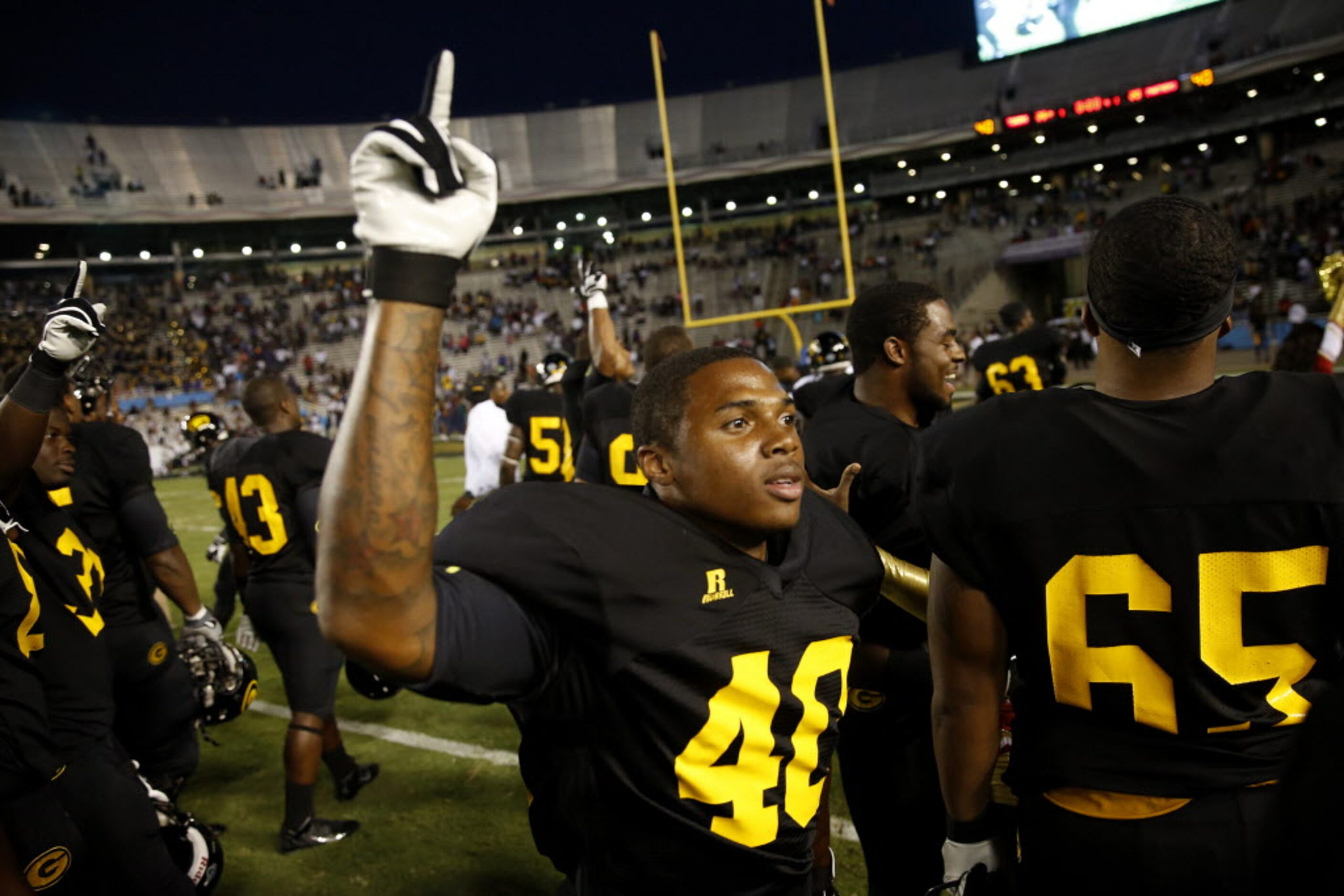 Grambling State defensive back Martez Carter (40) celebrates with teammates after beating...