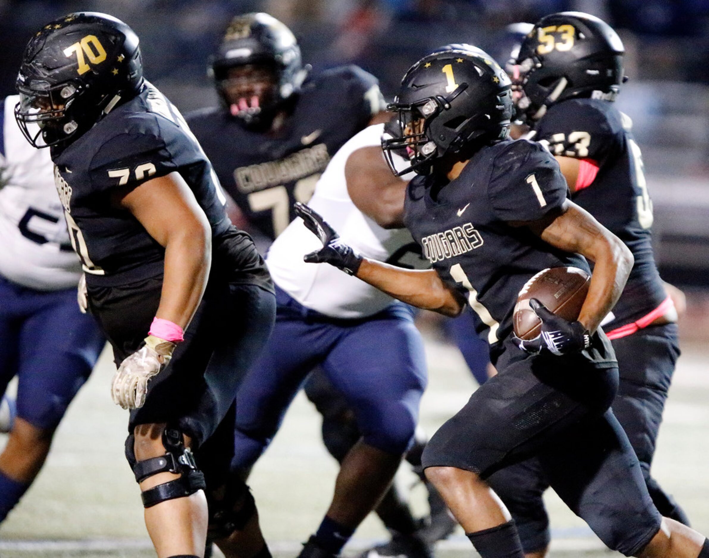 The Colony High School wide receiver Myles Price (1) follows the block of The Colony High...