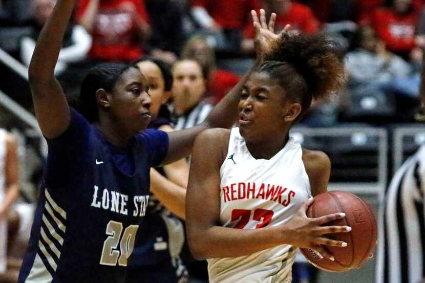 Liberty High School guard Randi Thompson (23) drives to the basket while defended by Lone...