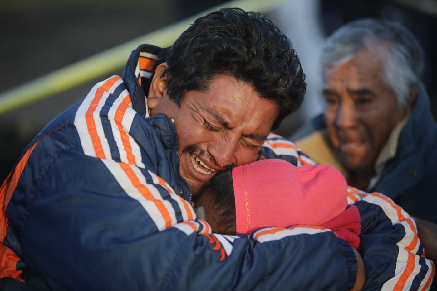 Family members of a victim cry when recognizing the body after an explosion in a pipeline...
