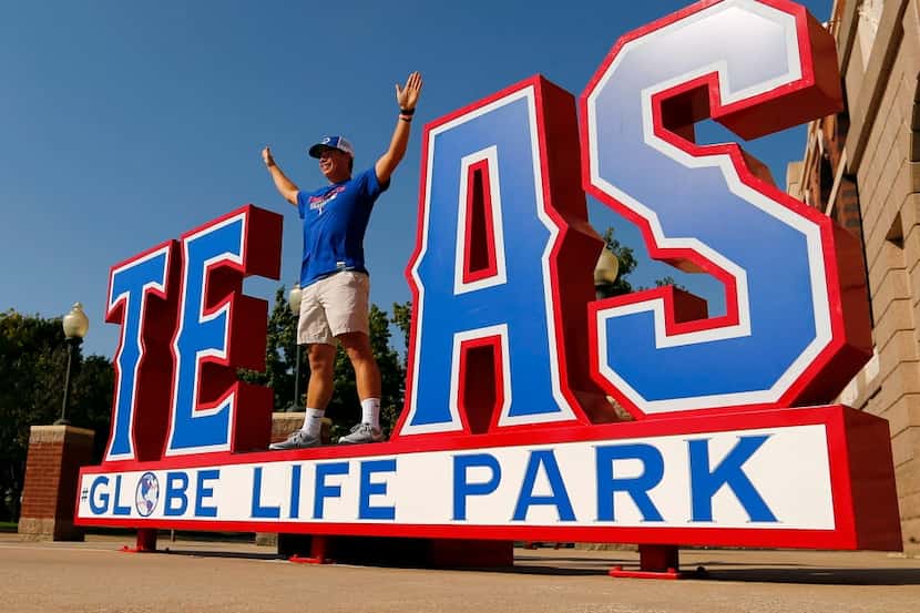 Texas Rangers fan Billy McGee of Strakville, MS poses as the X in Texas outside the gates ...
