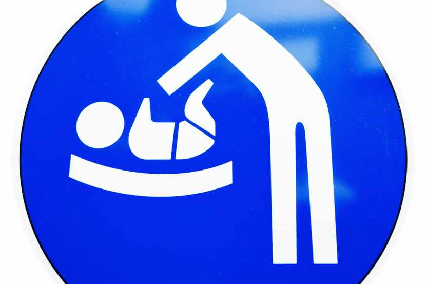 diaper changing table sign at a door