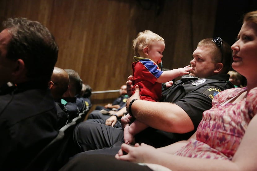 El Centro police Officer Andrew Maughan held his 11-month-old son, William, during a...