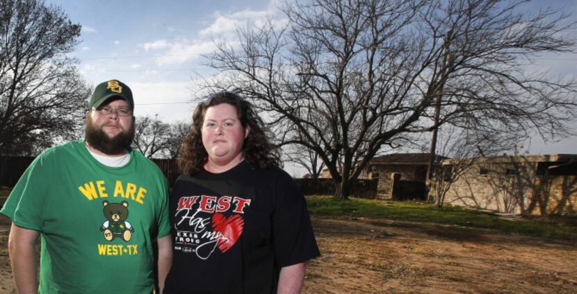 James and Rachel Matus stand where their house used to before the explosion. Several...