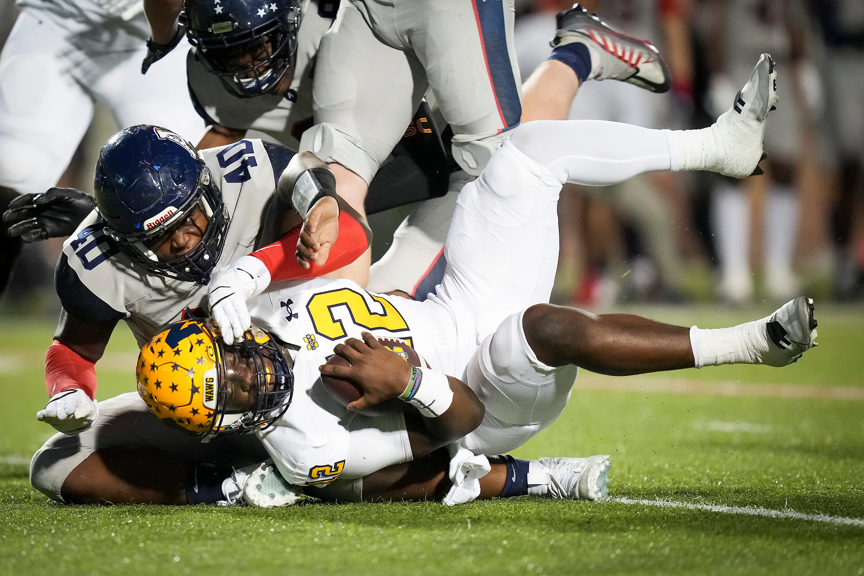 McKinney quarterback Keldric Luster (12) is sacked by Allen defensive lineman Nathan Marsh...