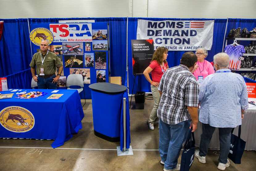 The Texas State Rifle Association booth is situated next to the Moms Demand Action booth...