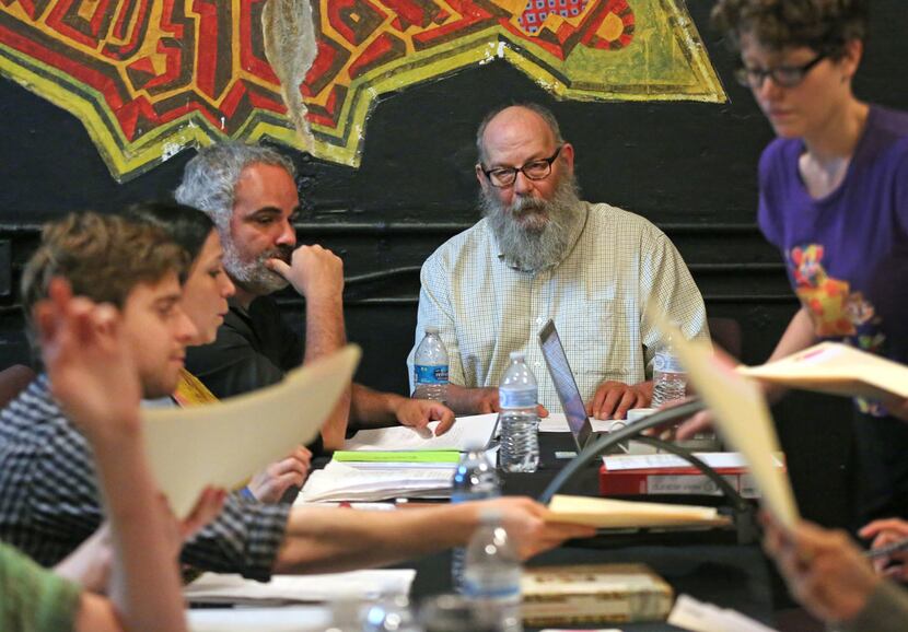 Ochre House Theater writer-director Matthew Posey (center) at a table read during the first...