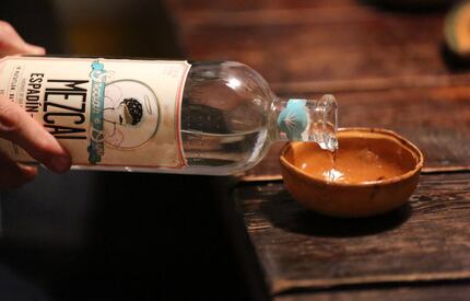 Mezcal is poured into small ceramic bowls for tasting during a party in Dallas. 