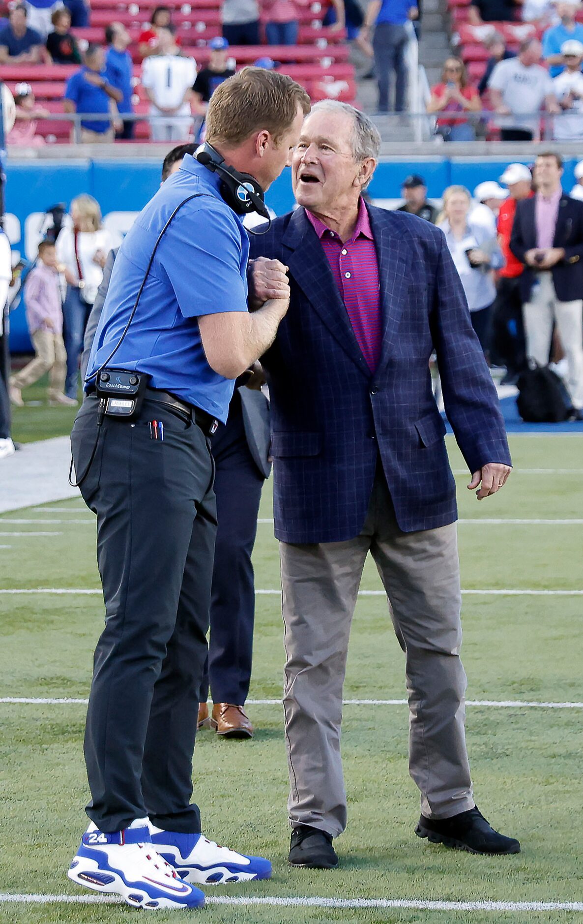 Former President George W. Bush (right) shakes hands with Southern Methodist Mustangs head...