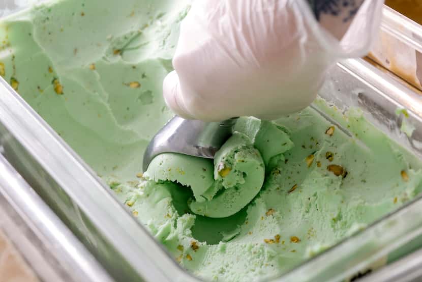 CEO Samantha Ofeno scoops pistachio ice cream at Dreamboat Donuts in Fort Worth.
