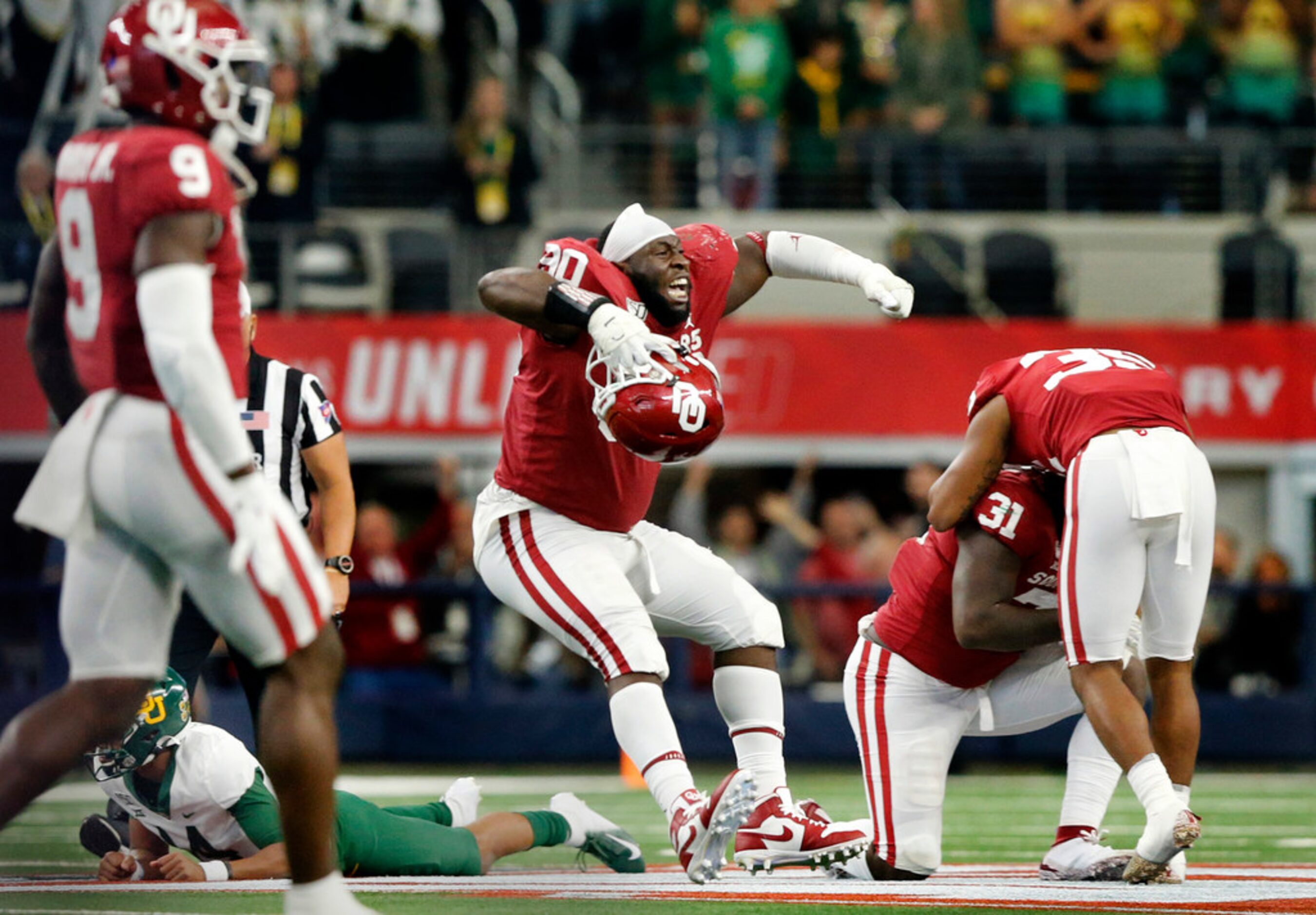 Oklahoma Sooners defensive lineman Neville Gallimore (90) and his teammates celebrate their...