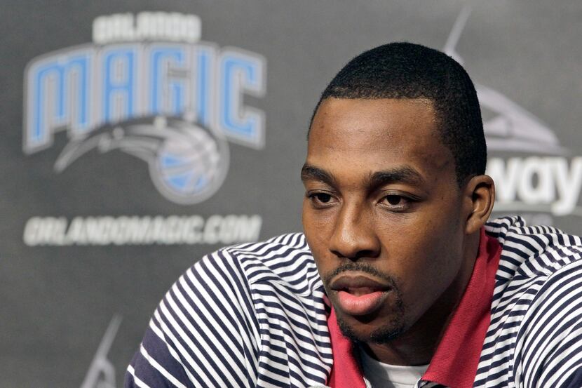 Orlando Magic center Dwight Howard answers questions during a news conference,Thursday,...