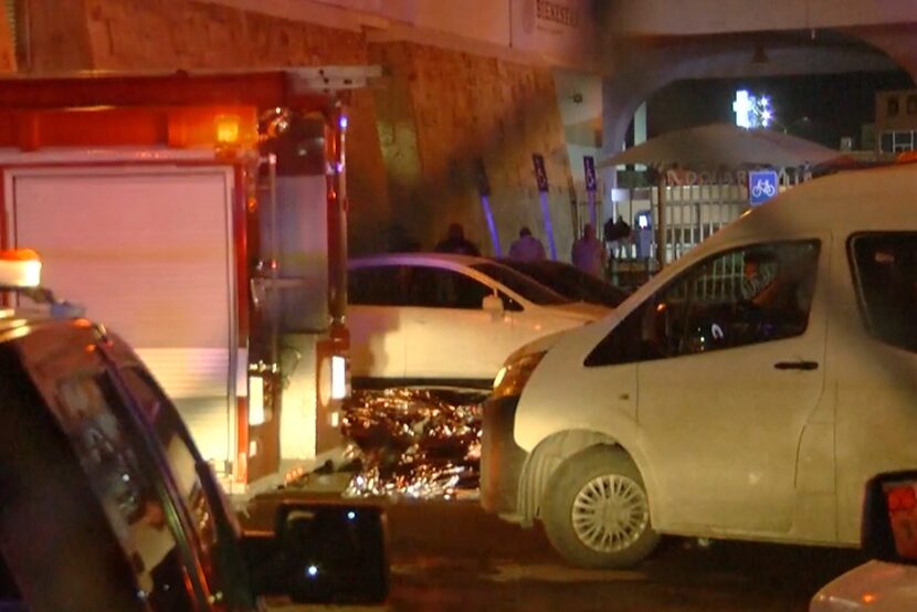 This image taken from a video shows bodies lying under  silver sheets outside an immigration...