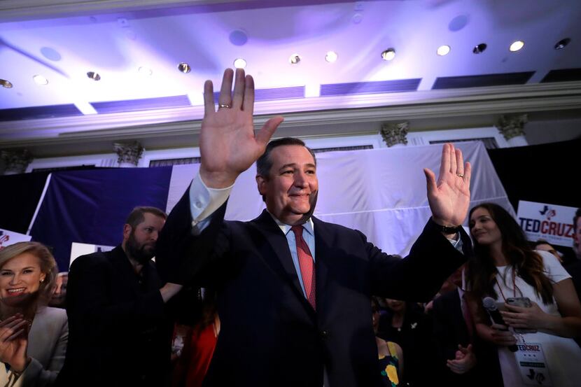 Sen. Ted Cruz raises his hands while delivering his victory speech during an election night...