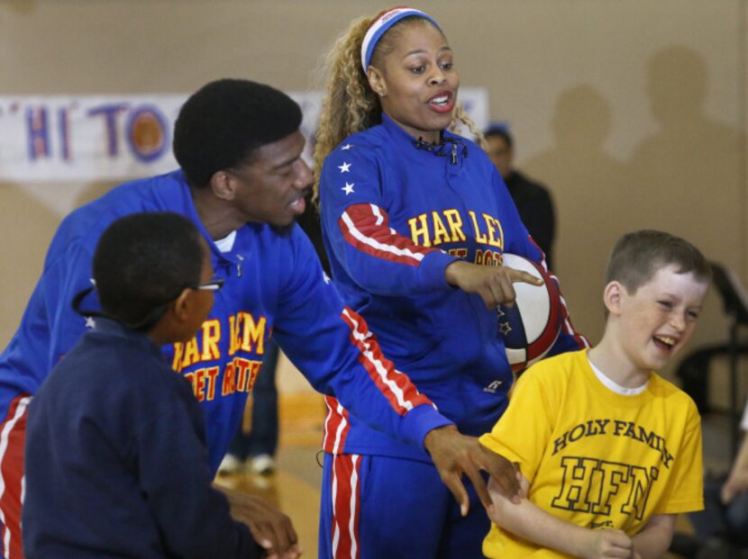 The Harlem Globetrotters' Joyce "Sweet J" Ekworomadu and teammate Anthony "Buckets" Blakes...