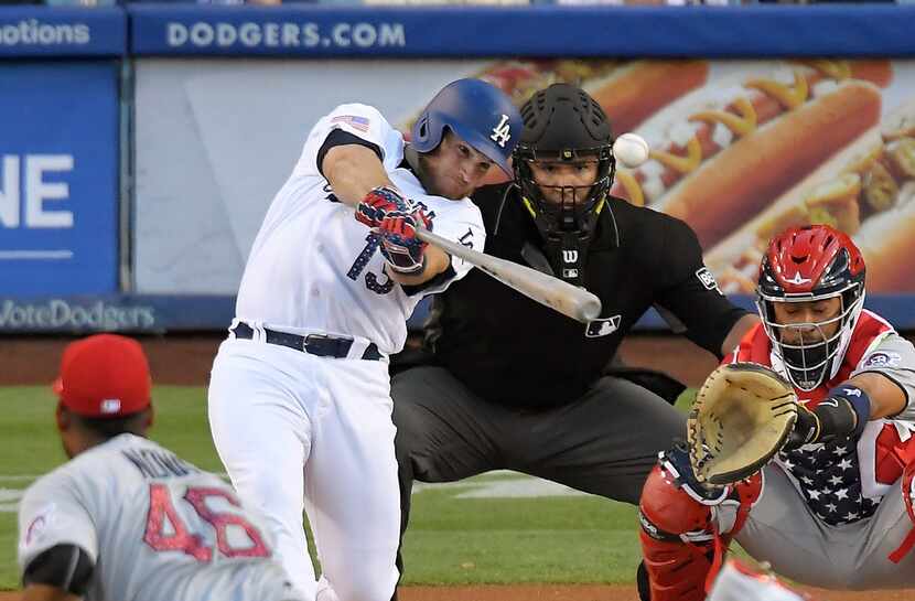 The Los Angeles Dodgers' Max Muncy hits a home run against the Pittsburgh Pirates on July 3,...