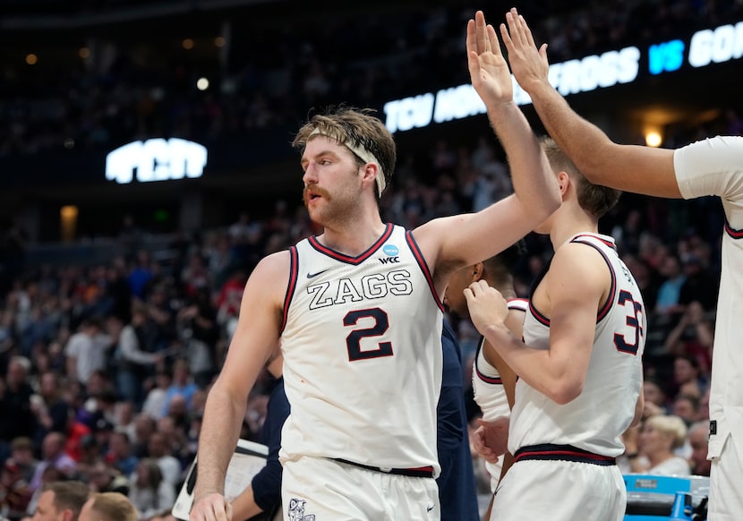 Gonzaga forward Drew Timme is congratulated as he heads to the bench late in the second half...