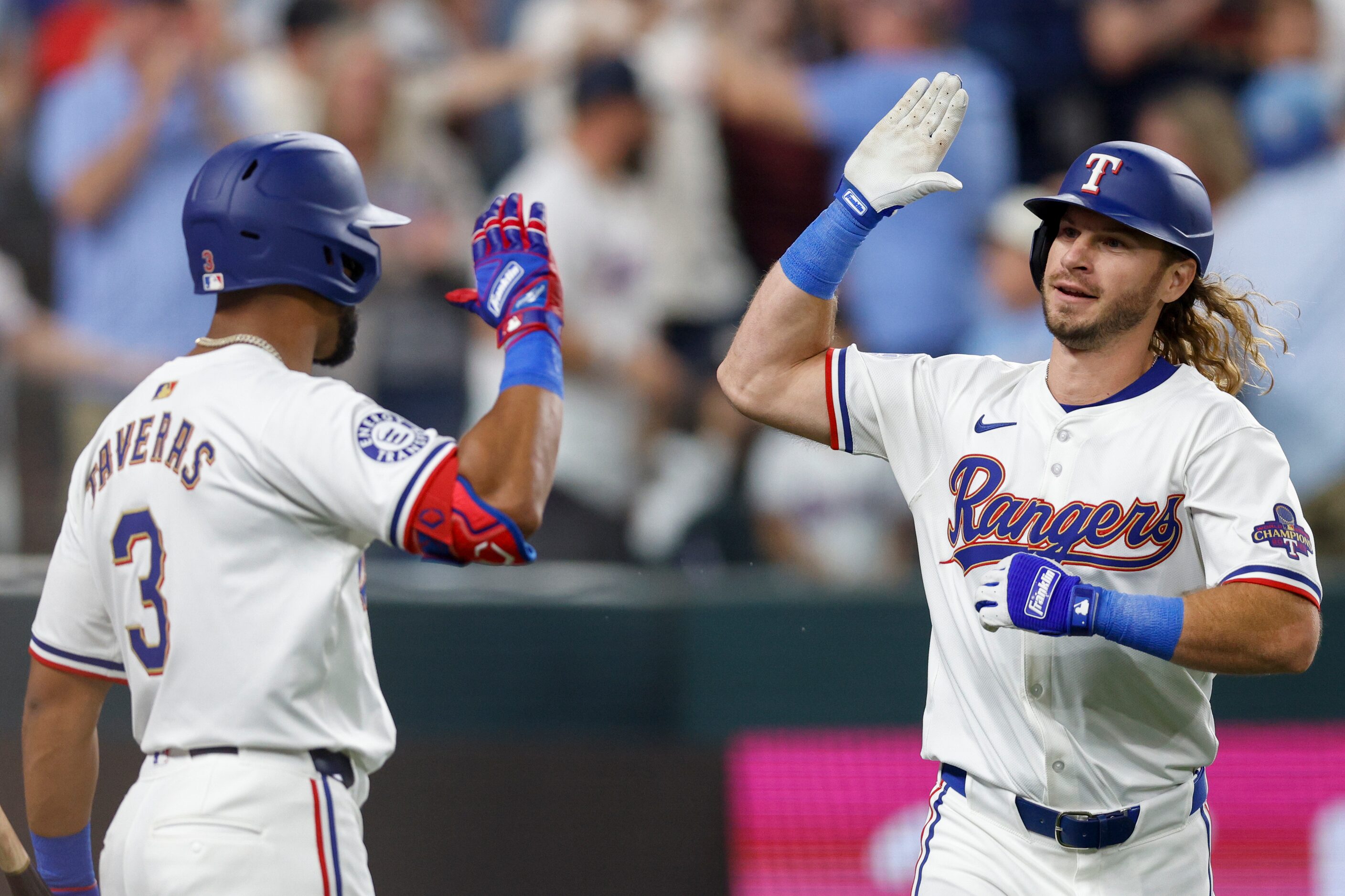 Texas Rangers left fielder Travis Jankowski (16) high fives center fielder Leody Taveras (3)...