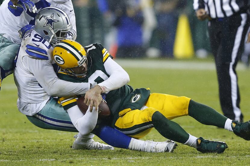 Dallas Cowboys defensive end Demarcus Lawrence (90) sacks Green Bay Packers quarterback...