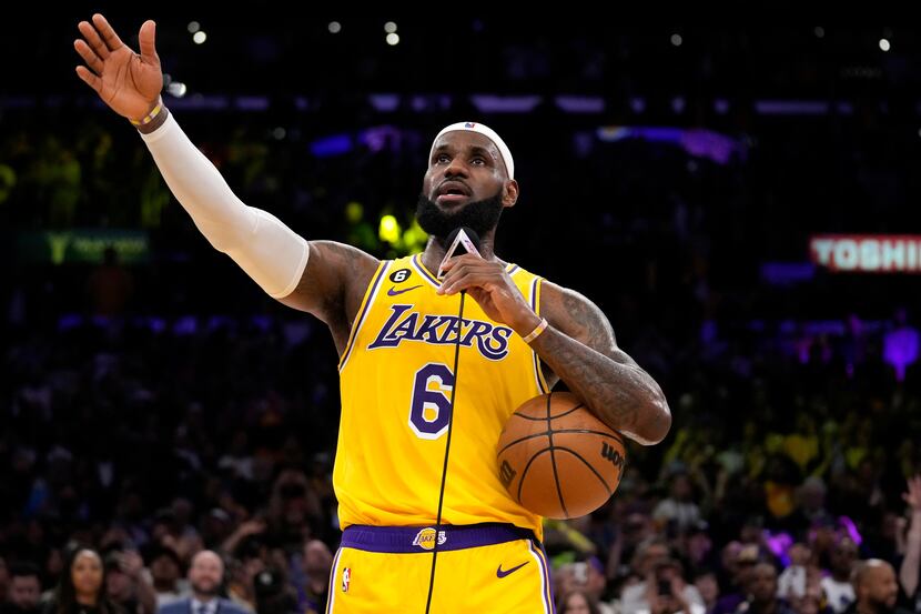 Los Angeles Lakers forward LeBron James speaks to fans after passing Kareem Abdul-Jabbar to...