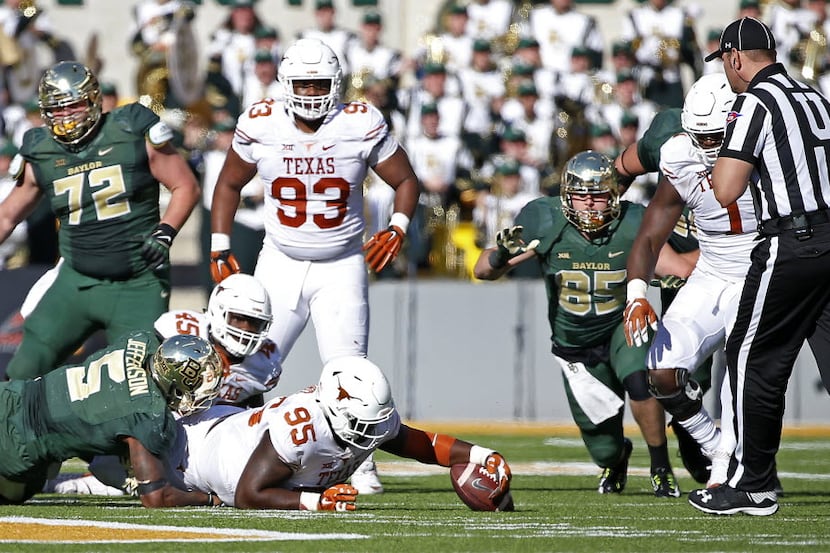Texas defensive tackle Poona Ford (95) recovers a fumble by Baylor running back Johnny...