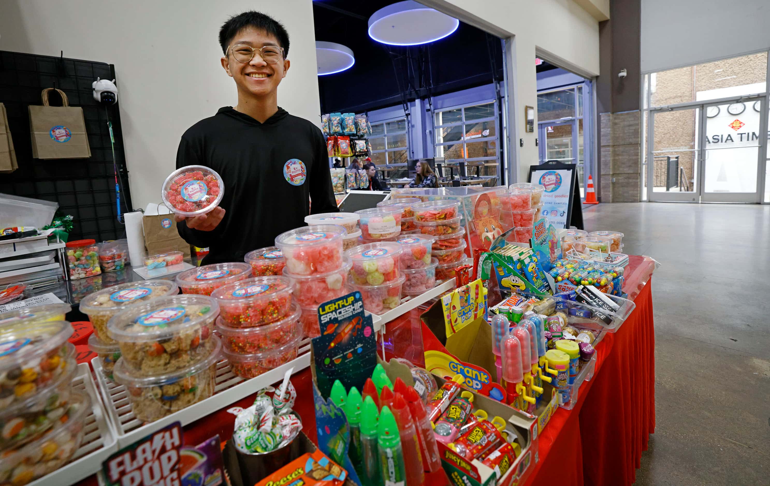 K Puffs Goodies owner Adrick Phan poses for a photo at his shop at Asia Times Square,...