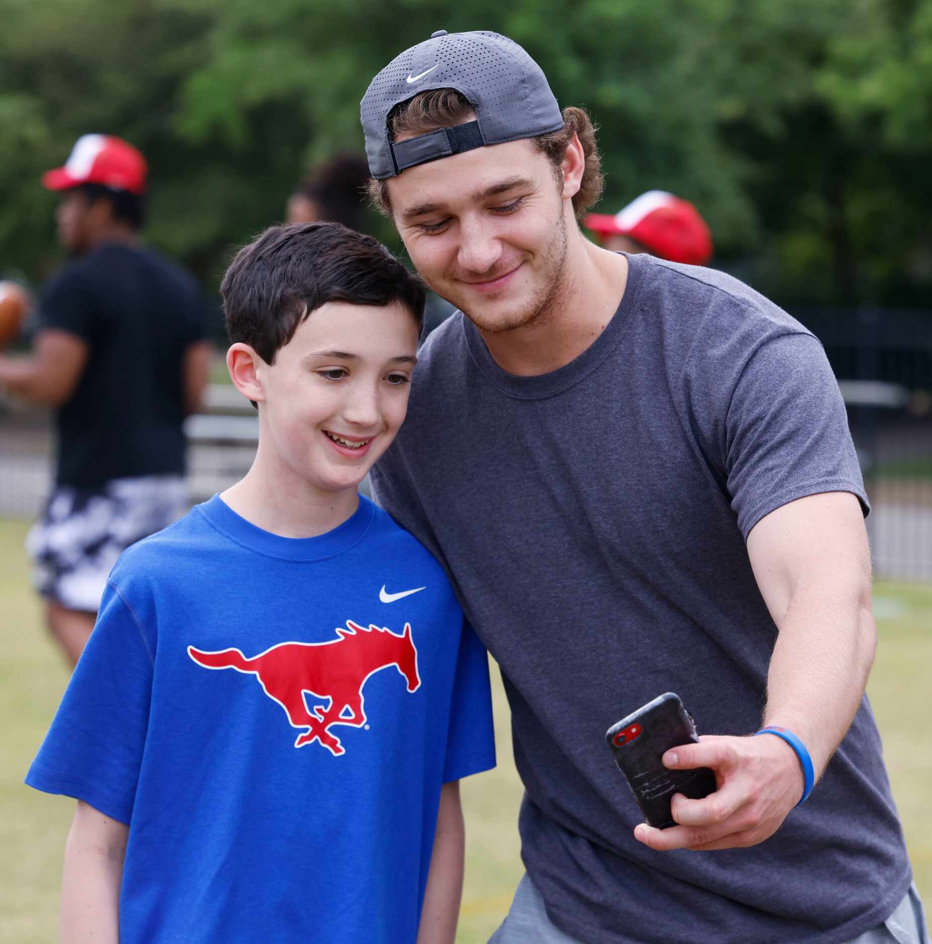 SMU QB Preston Stone (right) takes a selfie with Sam Silva during a special session of...