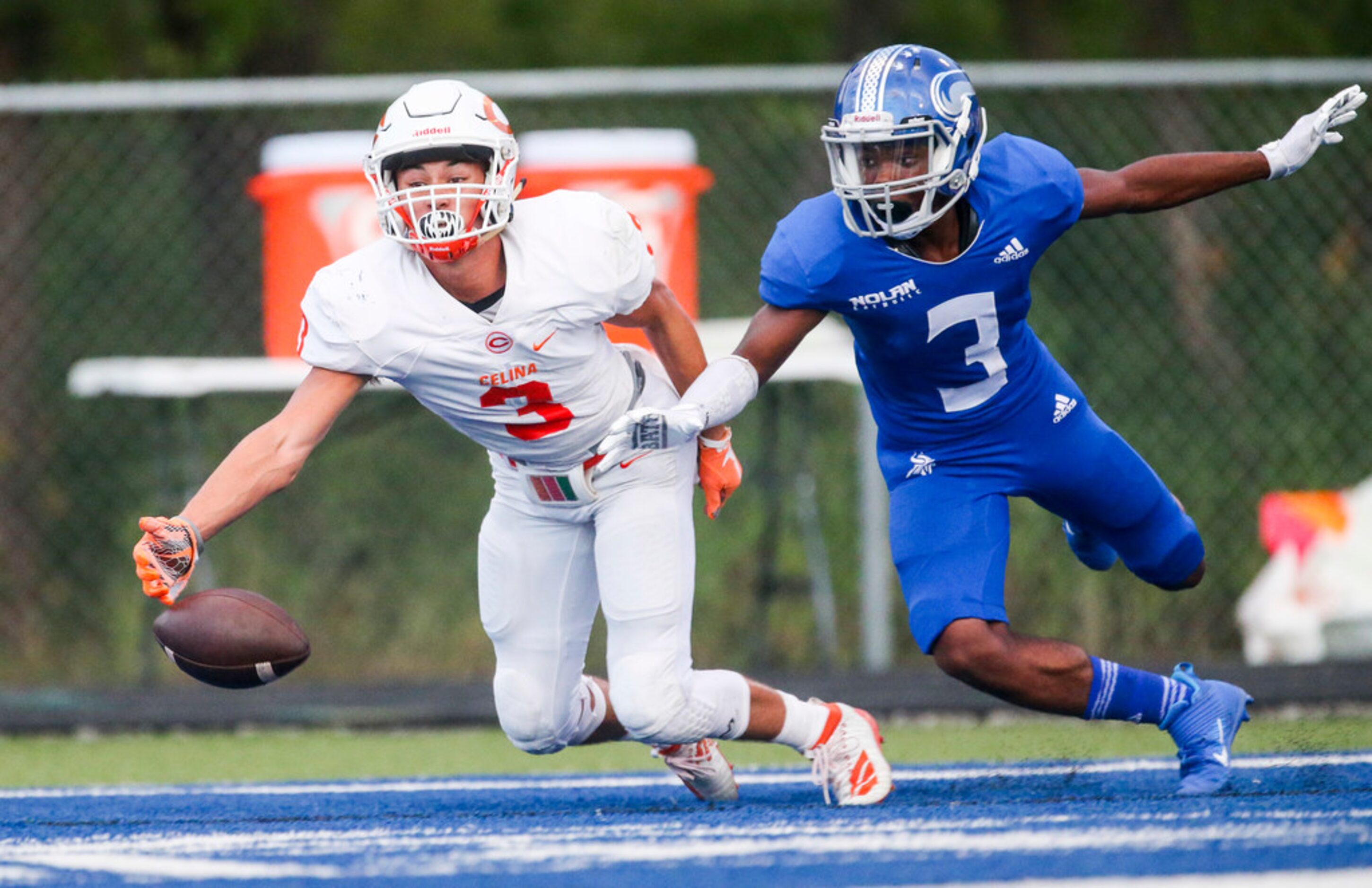 Celina wide receiver Grayson Wester (right) attempts to catch pass as he is defended by...