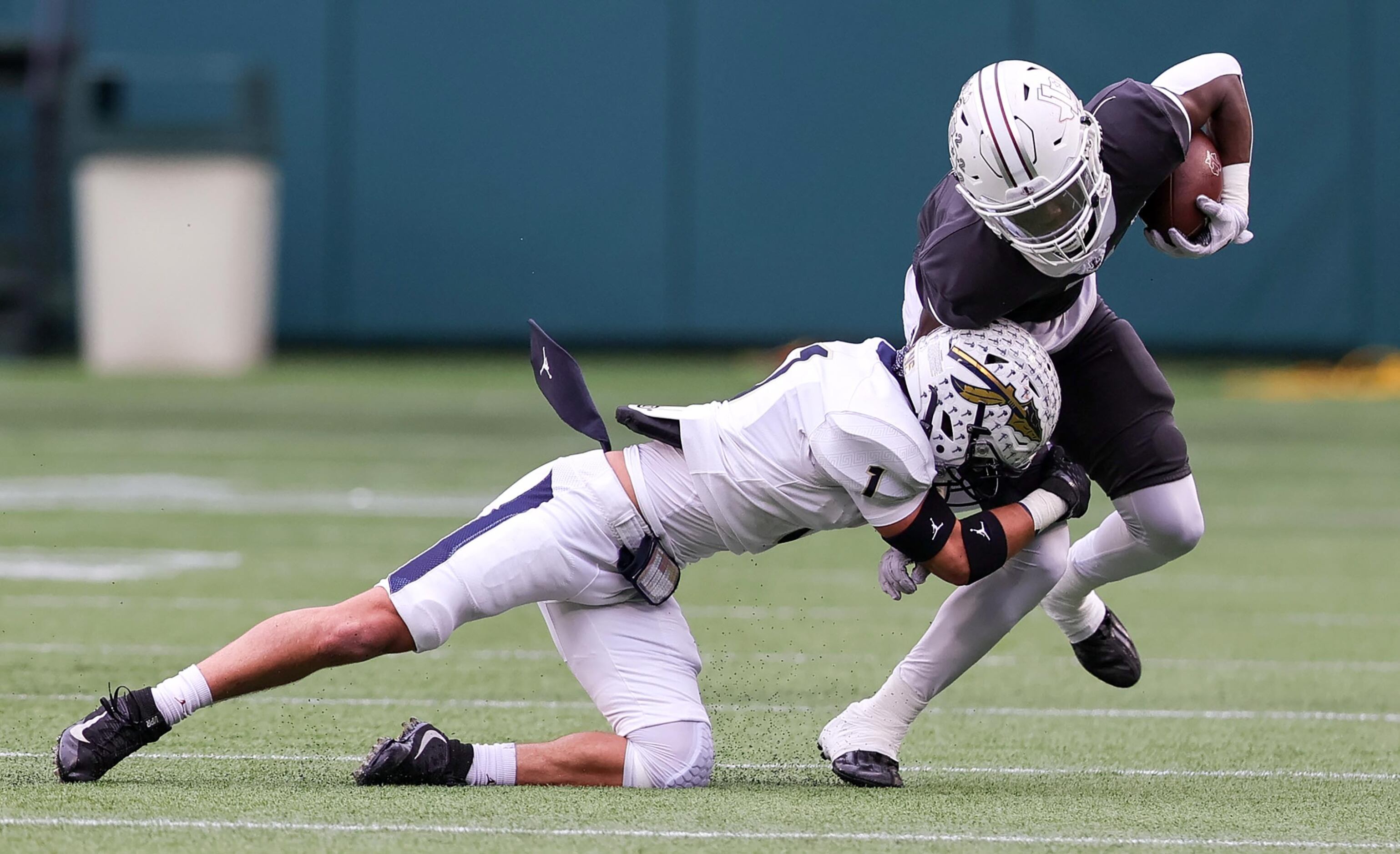 Lewisville wide receiver Lamar Kerby, (right) comes up with a reception and is brought down...