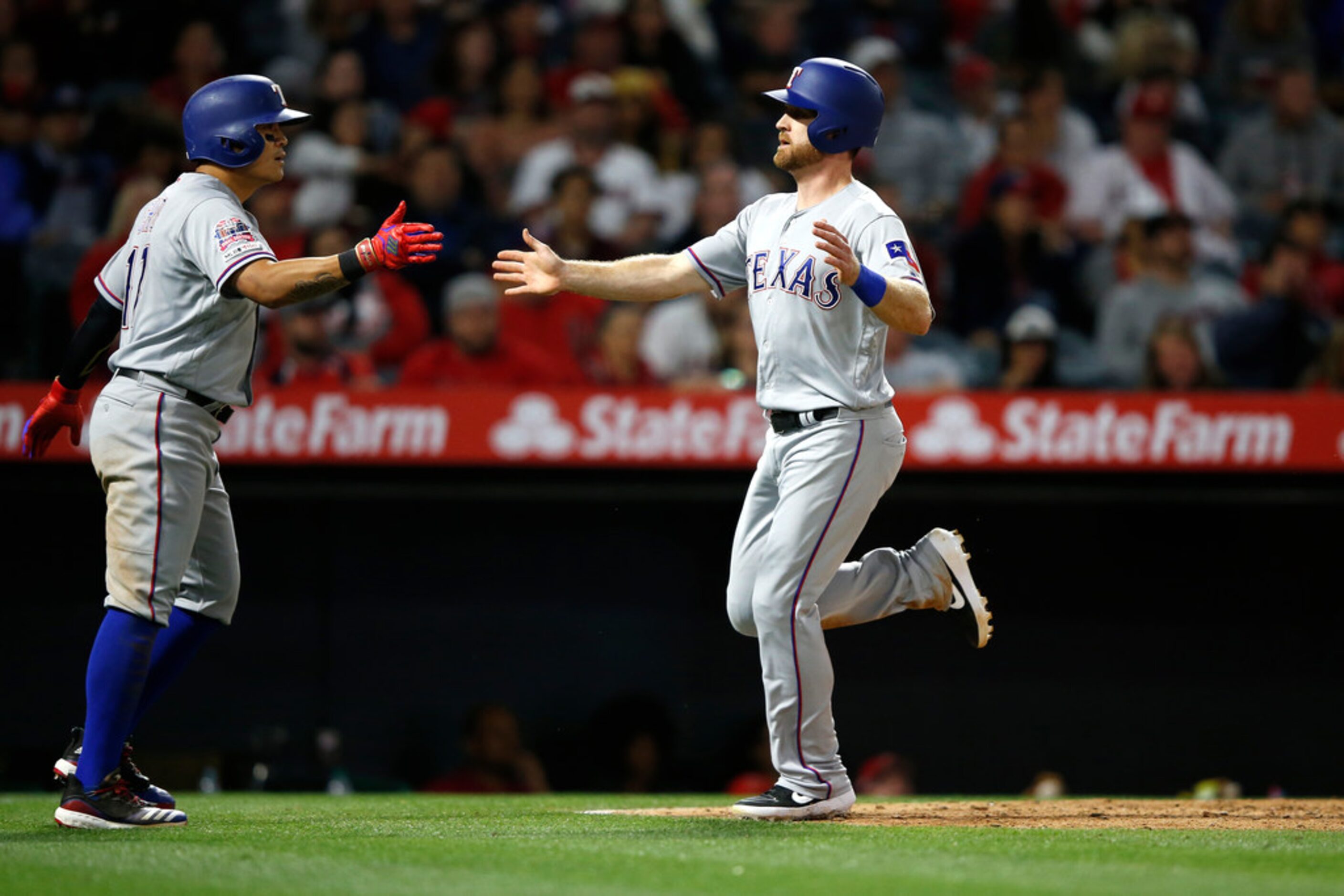 ANAHEIM, CALIFORNIA - MAY 24:  Shin-Soo Choo #17  is congratulated by Logan Forsythe #41 ...