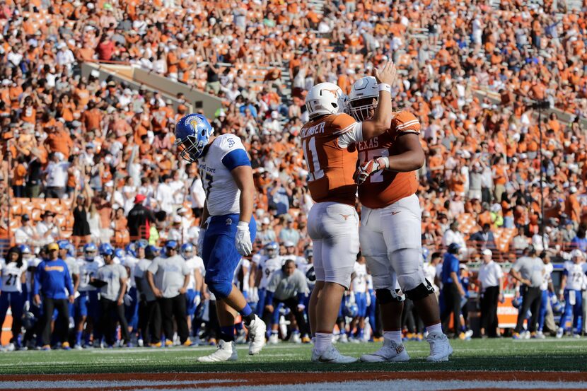 AUSTIN, TX - SEPTEMBER 09:  Sam Ehlinger #11 celebrates with Patrick Vahe #77 of the Texas...