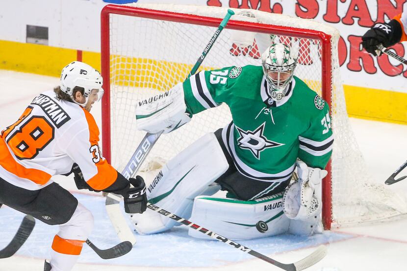 Dallas Stars goaltender Anton Khudobin (35) makes a save during an NHL hockey game at...