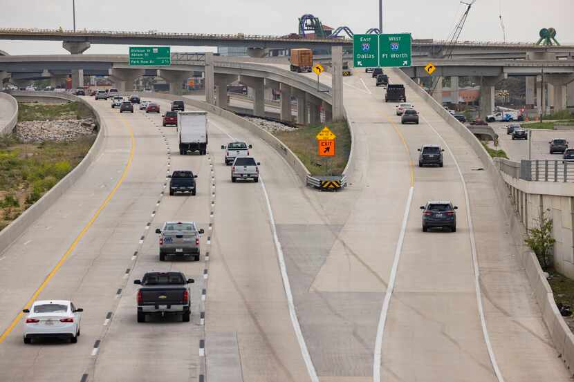 Drivers take the new flyover ramps east and westbound onto Interstate 30 from U.S. Highway...