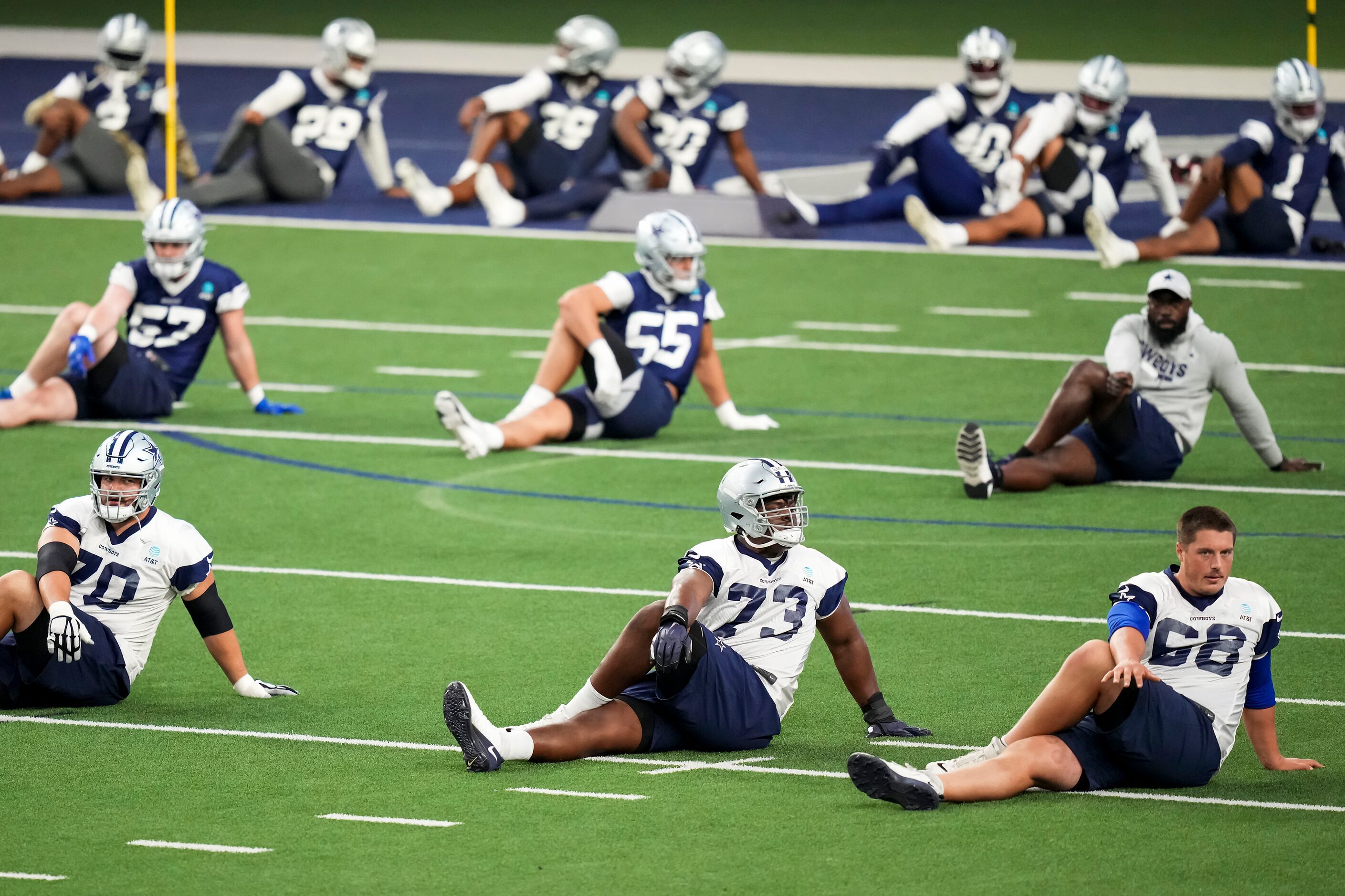 Dallas Cowboys players, including guard Zack Martin (70), offensive lineman Tyler Smith (73)...