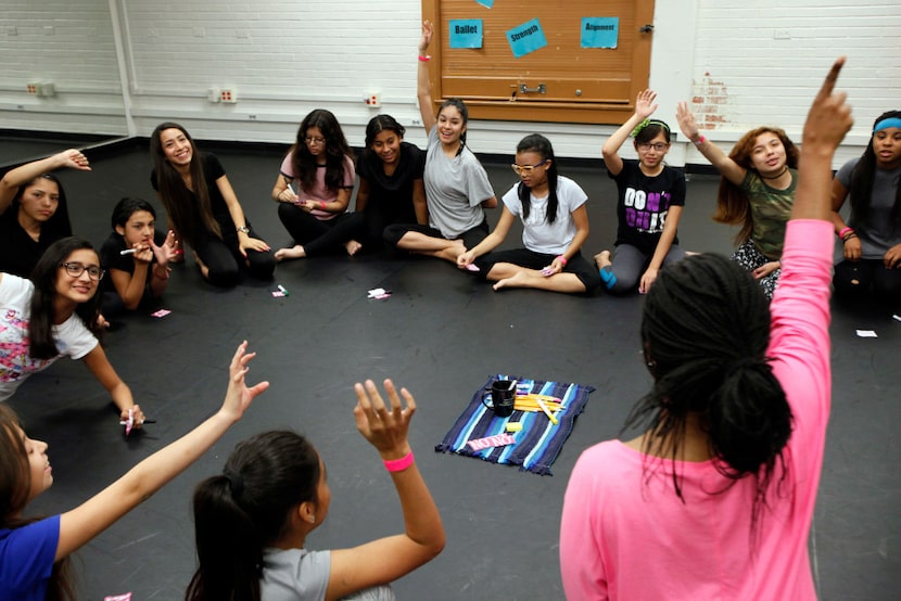 Dance teacher Alexis Brisby, far-right, asks her students to raise their hand during a vote...