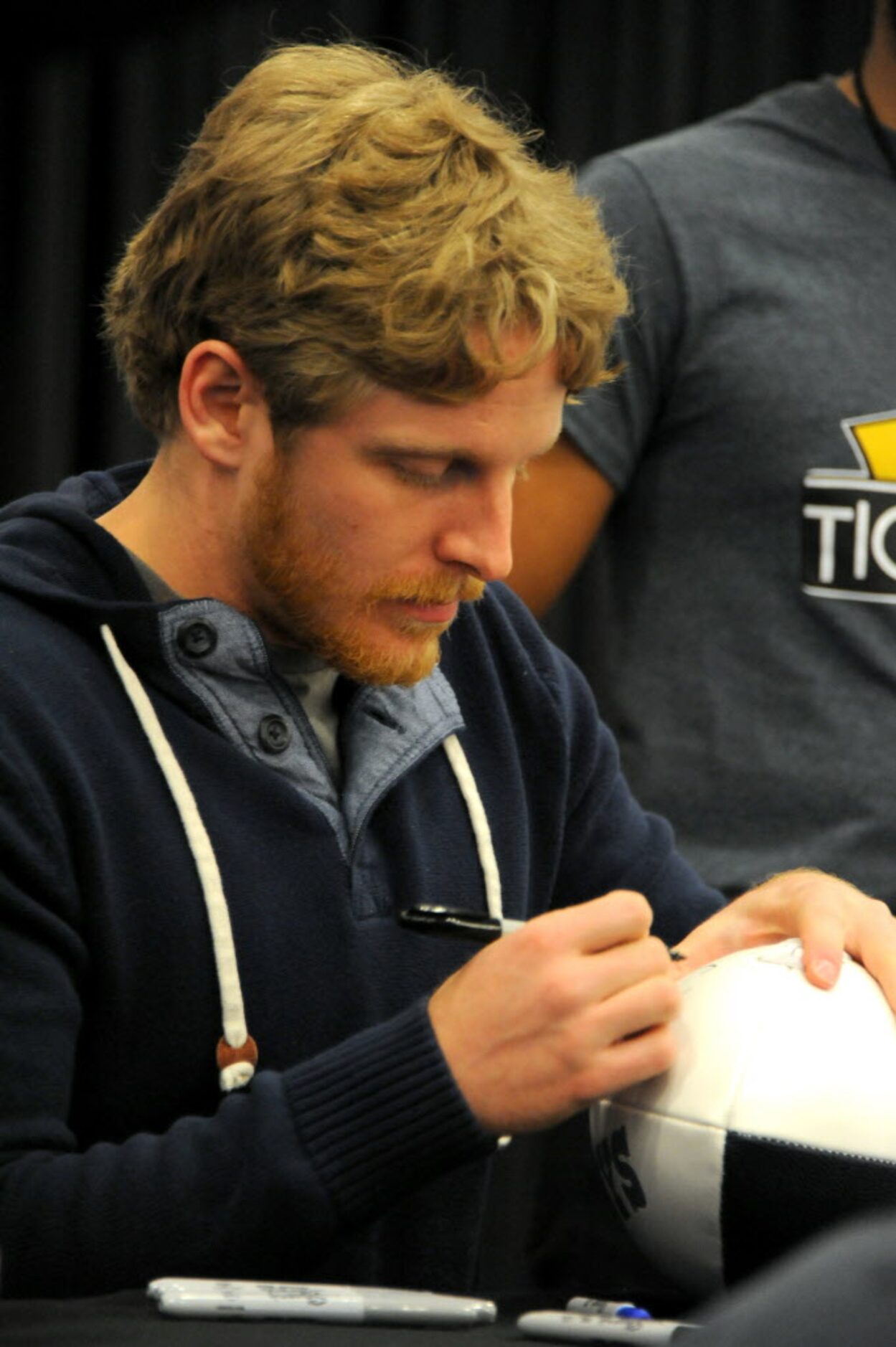 Dallas Cowboys wide receiver Cole Beasley signs a football for a fan at The Ticket...