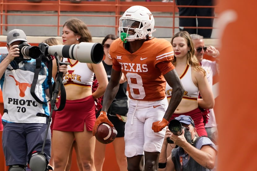 Texas wide receiver Xavier Worthy (8) celebrates his touchdown catch against Iowa State...