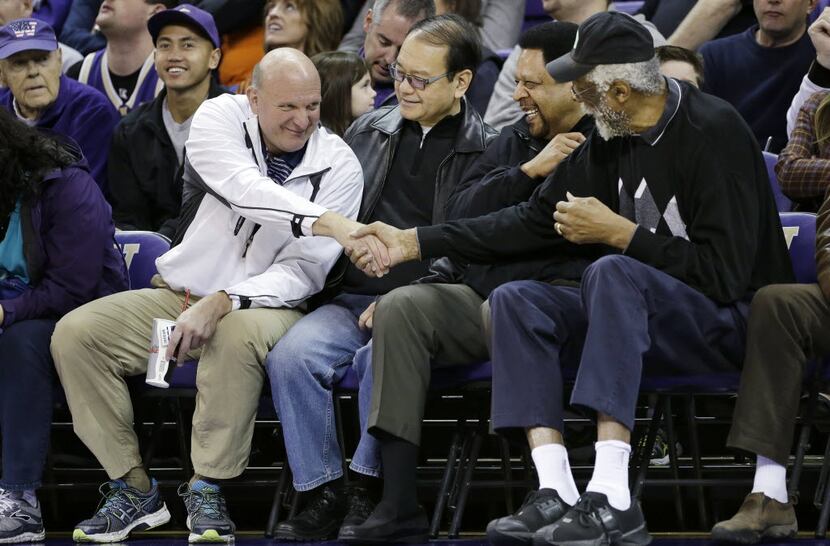 Steve Ballmer shakes hands with former NBA players Bill Russell, right, and "Downtown"...
