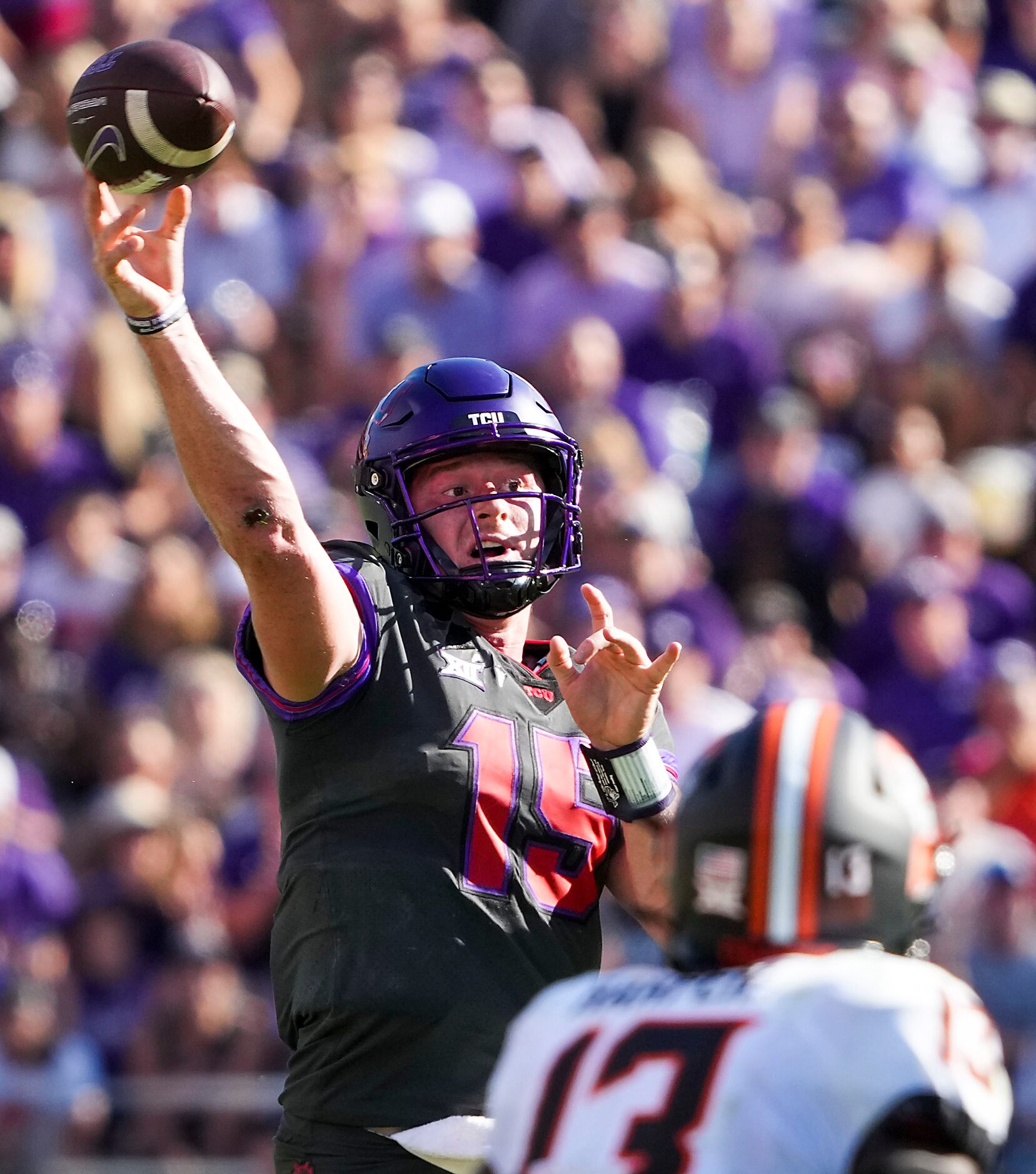 TCU quarterback Max Duggan (15) throws a pass during the first half of an NCAA football game...