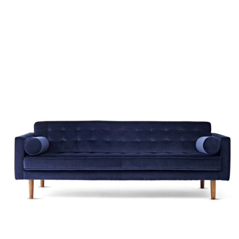 Jonathan Adler's Crescent Heights tufted sofa, in navy blue, is $2,895 at J. C. Penney.