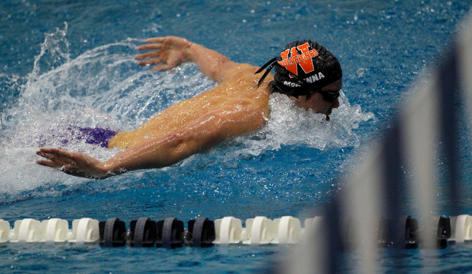 Freak Wakeland's Conor McKenna finishes strong to win the Boys 100 Yard Butterfly event with...