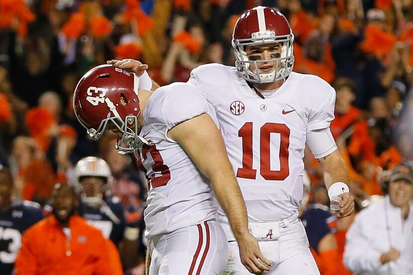 AJ McCarron #10 and Cade Foster #43 react after Foster missed a field goal in the third...