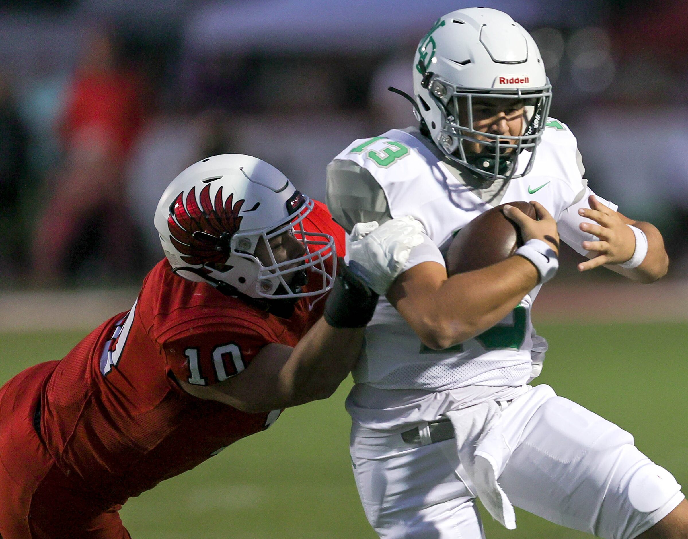 Lake Dallas quarterback Cade Bortnem (13) tries to break free of a tackle by Argyle...