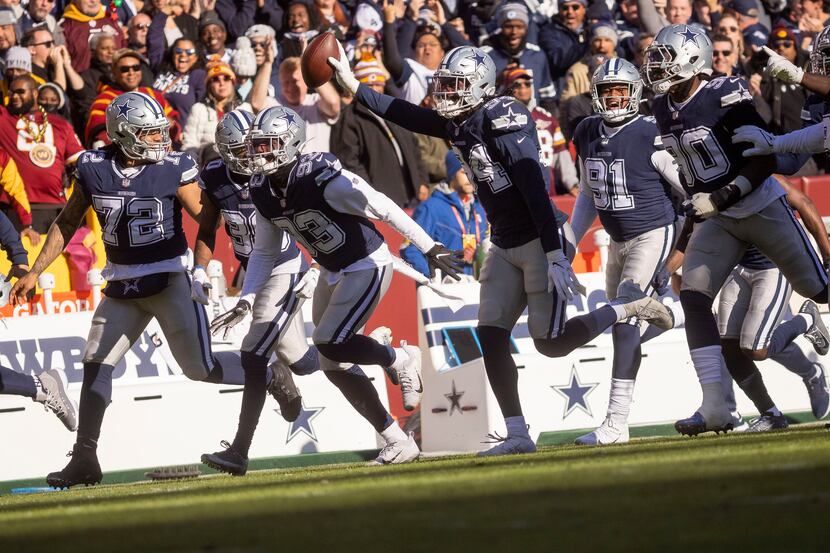 Players celebrate Dallas Cowboys defensive end Randy Gregory (94) pass interception of...